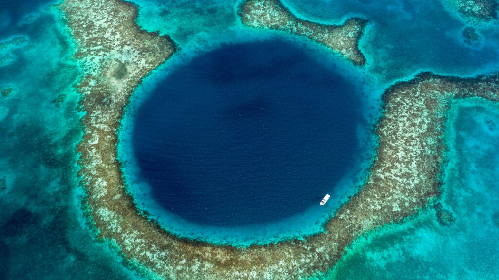 Aerial view of Belize’s Great Blue Hole, a UNESCO World Heritage Site. Photo by Duarte Dellarole/Shutterstock.com