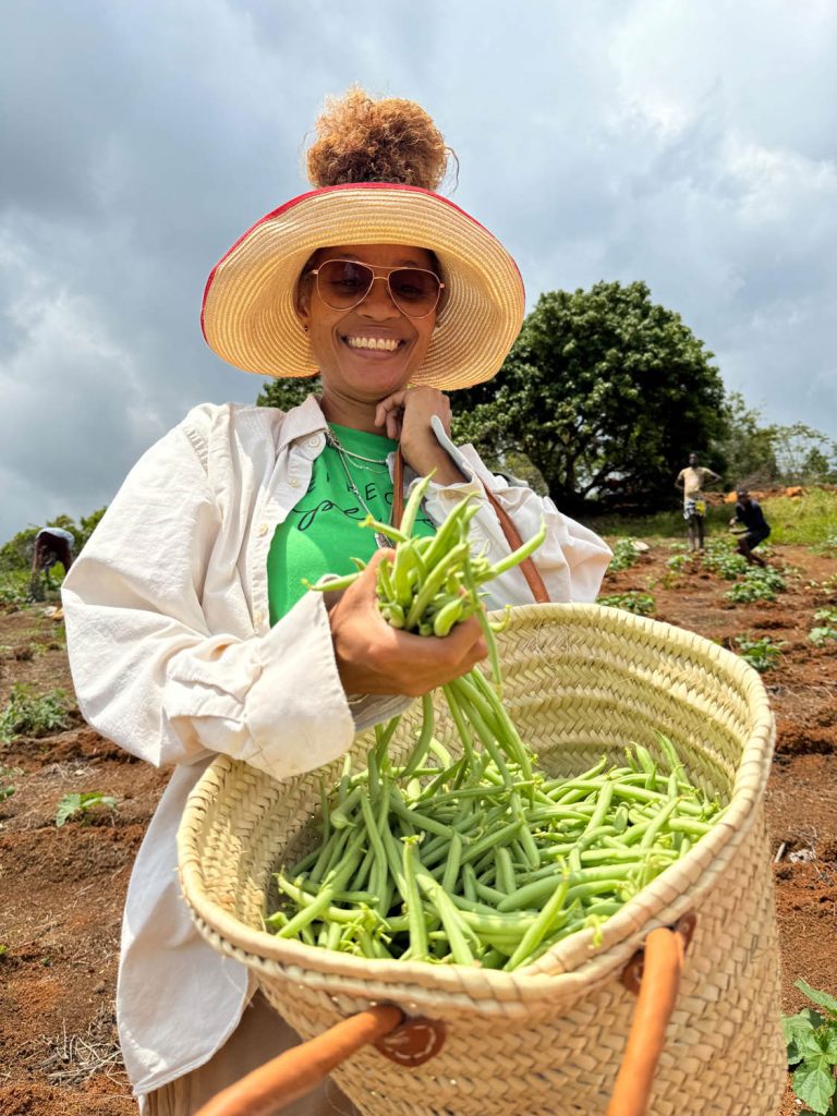 Chin shows off a basket of string beans grown at Kindred Farms. Photo courtesy Staceyann Chin