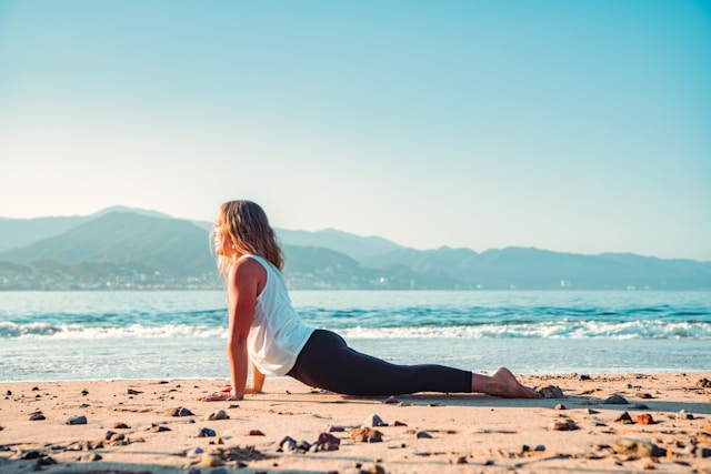 Person doing yoga at a beach