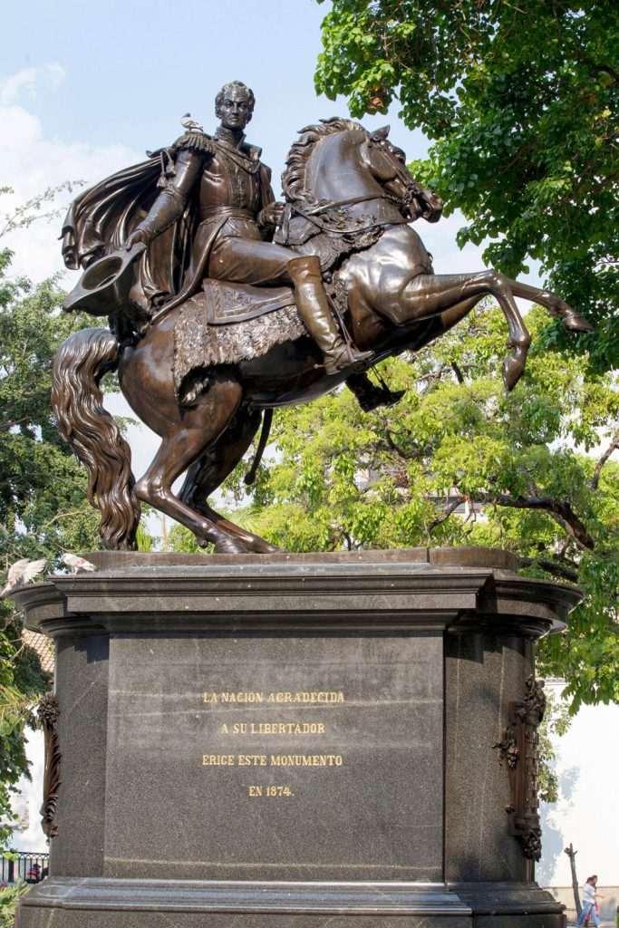 A bronze statue of Simón Bolívar, with a dove on his shoulder, in downtown Caracas. Photo by casa.da.photo/Alamy Stock Photo